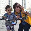 Stratford youngster Iker Reyes won a brand new bicycle when he picked up the lucky egg with the winning ticket. Joining him is Lions Club member Gina Arcino.